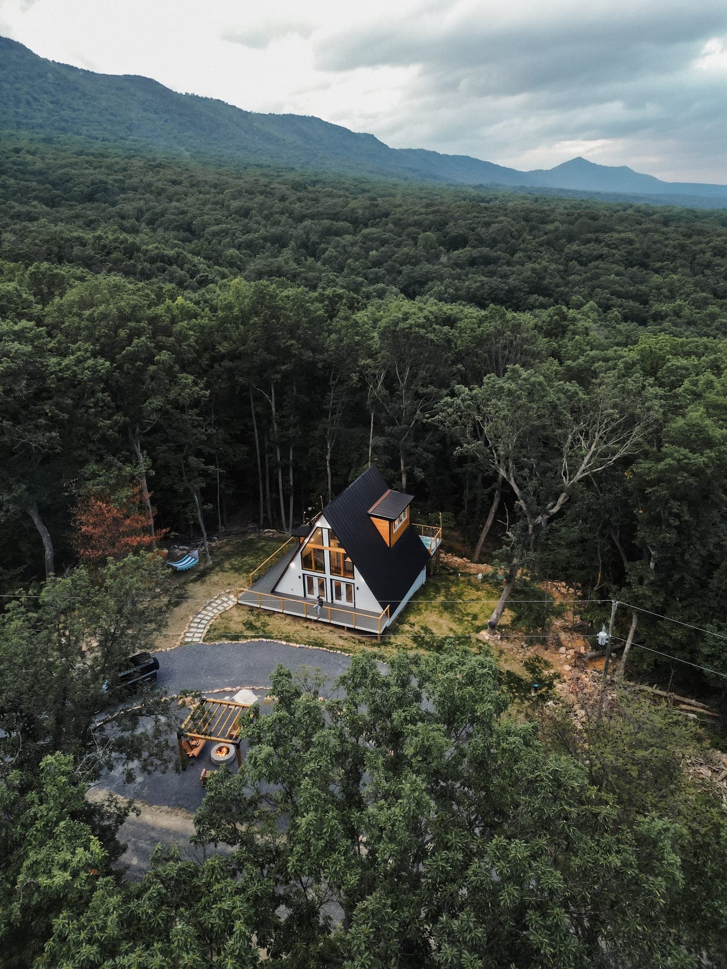 Aerial view of The Sparrow A-frame with the Blue Ridge Mountains behind