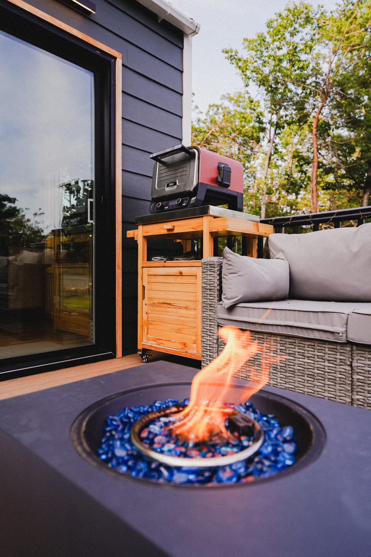 The Turtle's deck sofa and fire table lit at dusk