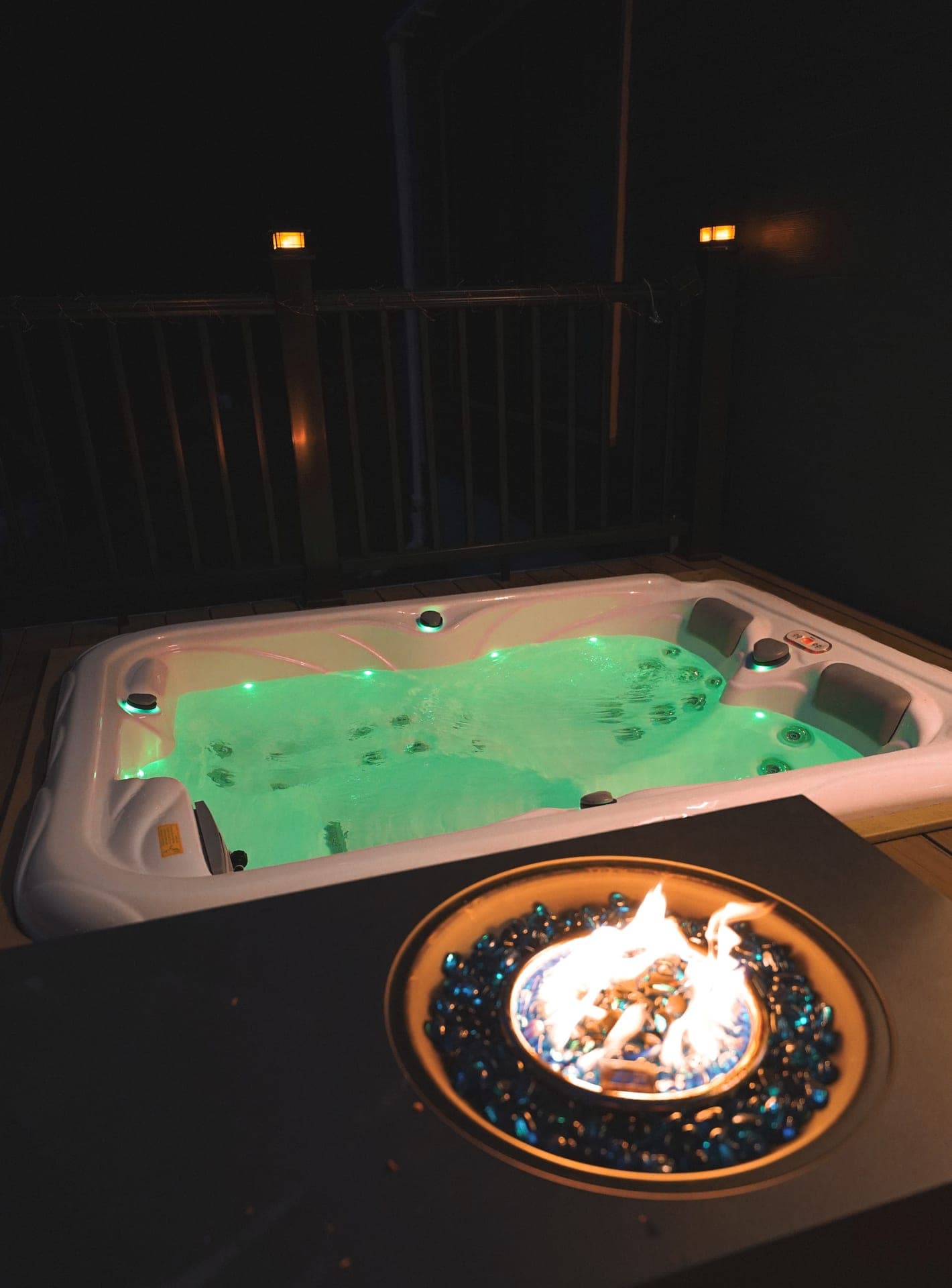 The Turtle's private hot tub lit at night on the deck outside Luray